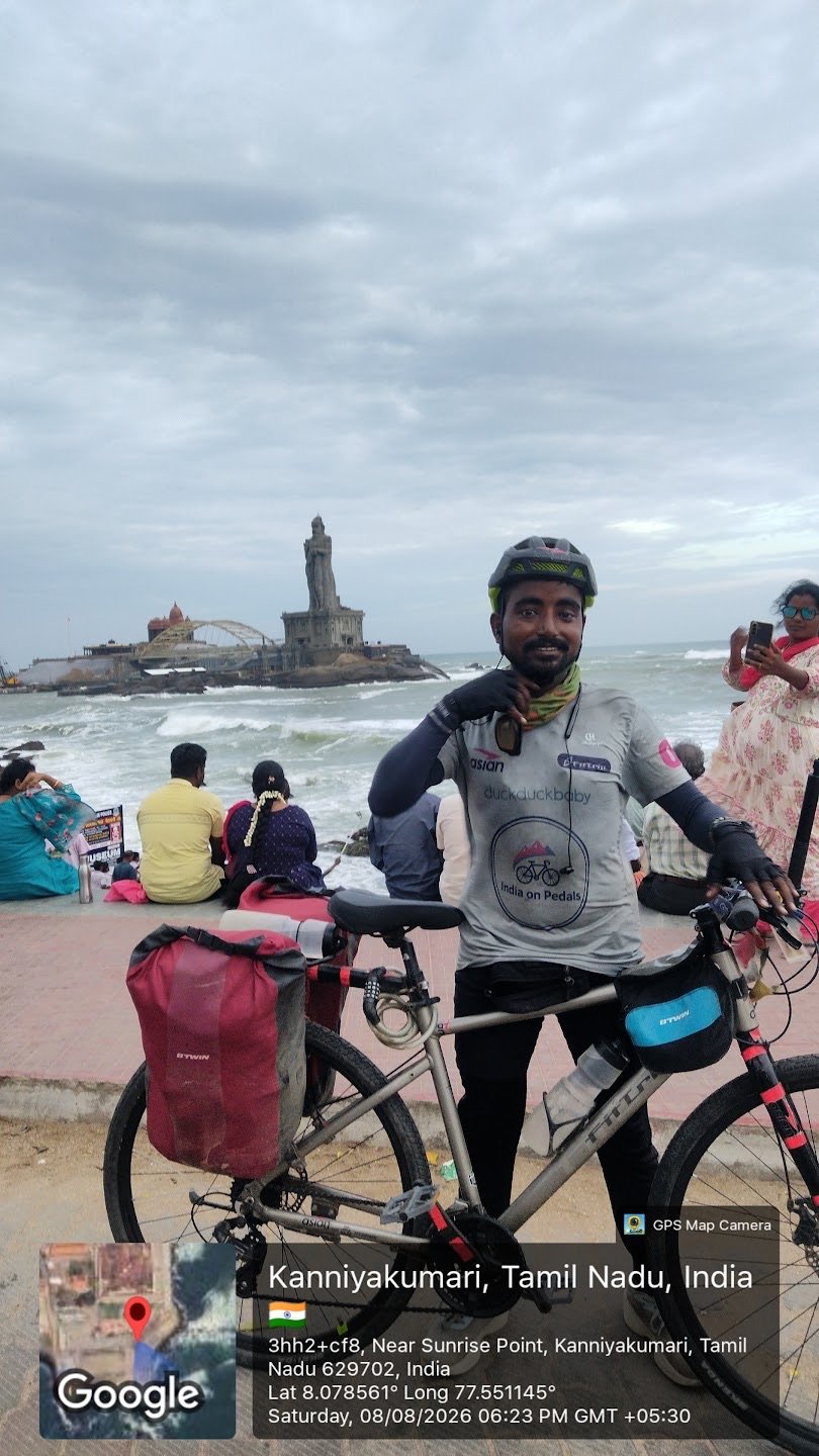 Shankar Kumar Thakur standing with his expedition bicycle at Kanniyakumari after completing the Leh to Kanniyakumari ride